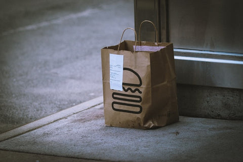 A bag of food delivery at a door unattended 