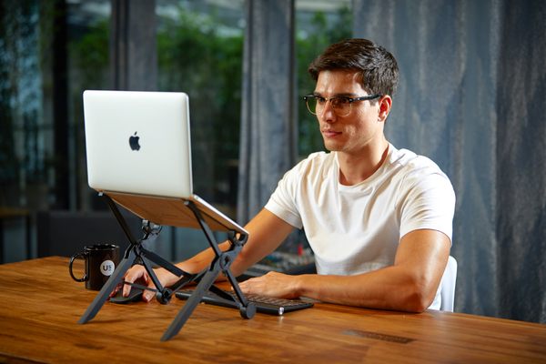 Man using a laptop stand
