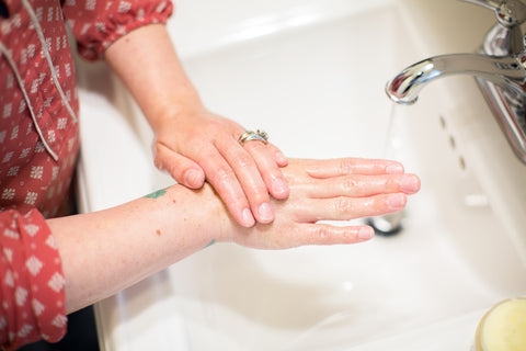 Woman washing hands at the sink