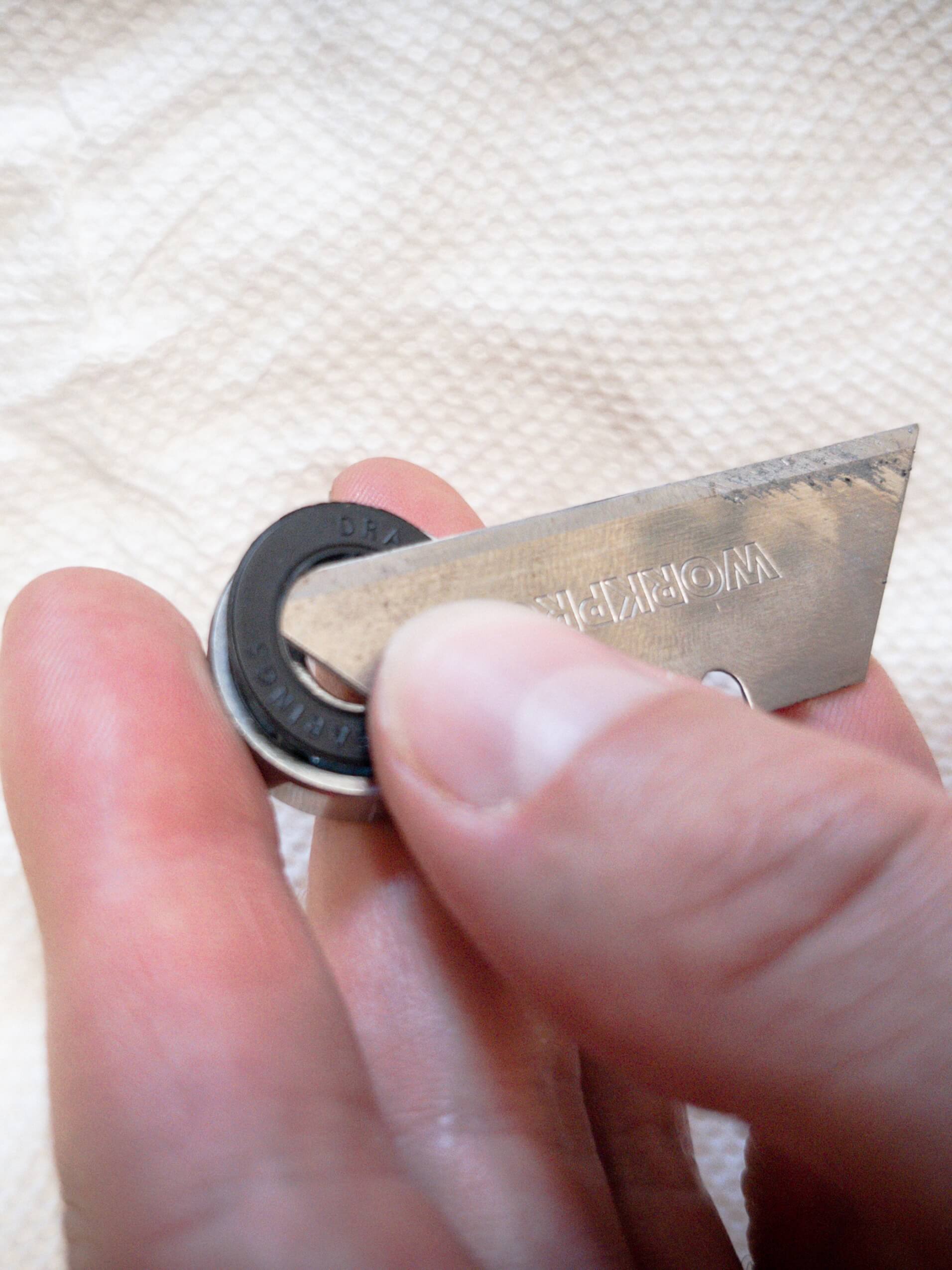 Pop off your skate bearing shield with a blade