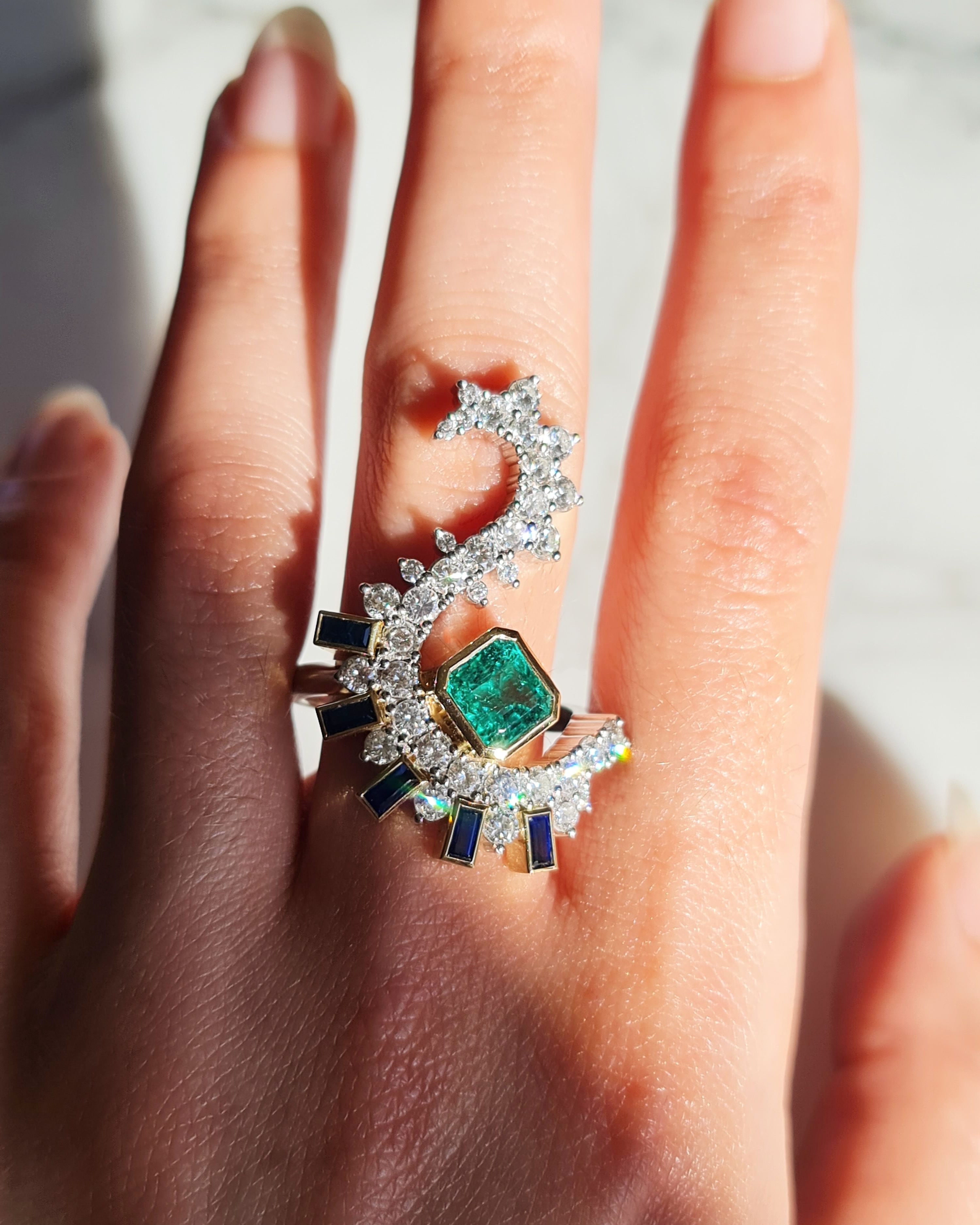 Layla Kaisi Collection bespoke cocktail ring featuring a cushion cut emerald, pear cut white diamonds, and sapphires
