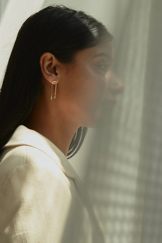 An elegant model wearing a pair of diamond earrings