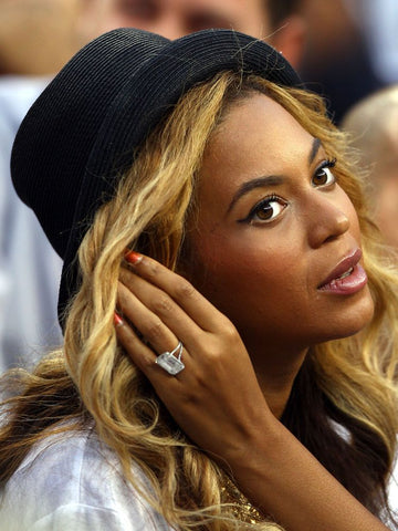 Beyonce sitting in a basketball courtside
