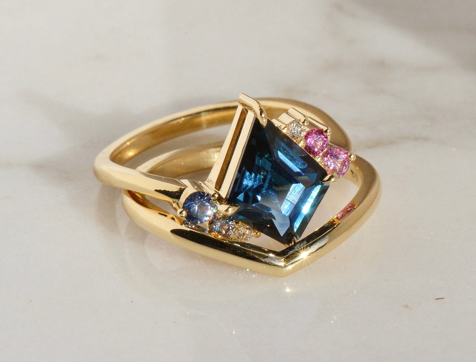 Sapphire engagement ring and gold wedding band designed by Layla Kaisi Collection