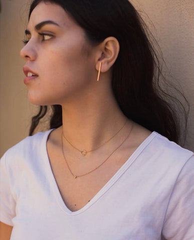 A model wearing layered necklaces