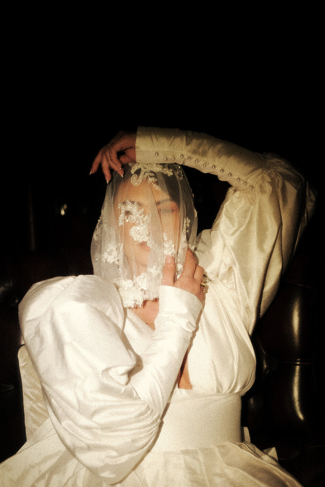 A bride covering her face with a veil