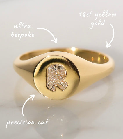 A bespoke Gold Signet Ring featuring custom cut diamond letter