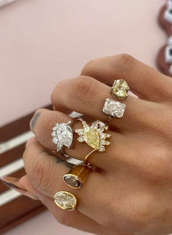 A hand adorned with a variety of unique rings, each gracefully placed on different fingers, showcasing individual styles and designs from Layla Kaisi Collection