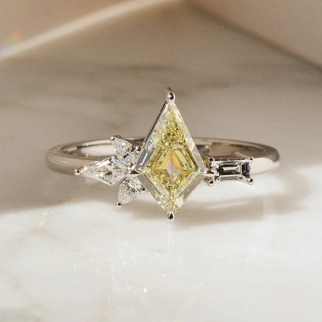 Kite cut yellow diamond engagement ring with asymmetrical accent stones