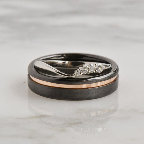 A close-up of a Diamond Wedding Ring Placed on a black grey shiny Jewellery box.