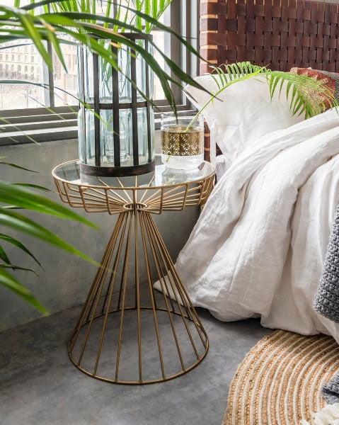 Gatsby Birdcage Side Table has an antique gold finish, a striking geometric base and glass tabletop. Available from Cuckooland