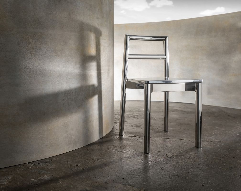 Silver chair by Didier against a concrete background