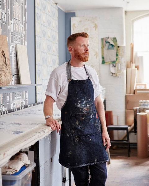 Independent wallpaper, textile and surface designer Daniel Heath stood in his London studio