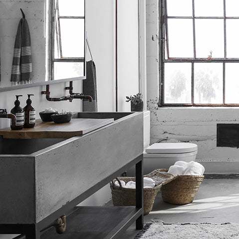 industrial bathroom scheme in a converted industrial loft features exposed brick and warehouse windows