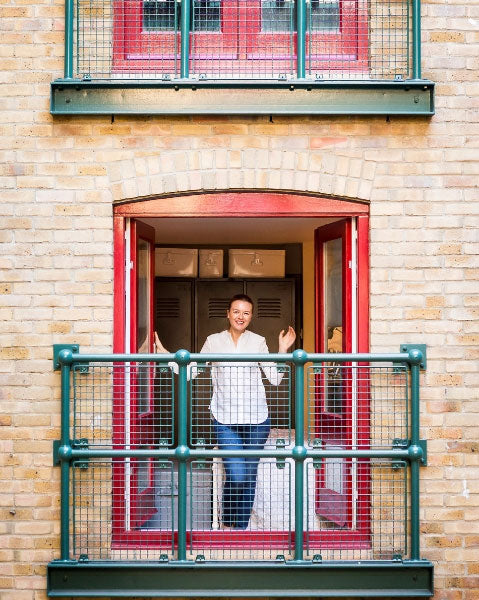 Warehouse Home founder Sophie Bush stood in a warehouse window