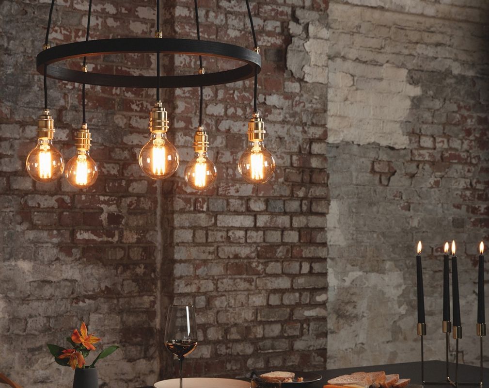 Tom Raffield Noctis Kern Pandant light suspended over a dining table