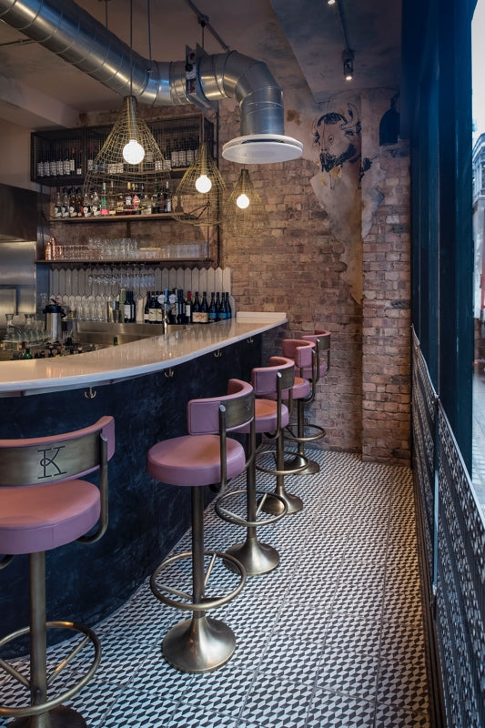The bar at Kricket Soho designed by Run For The Hills features industrial materials