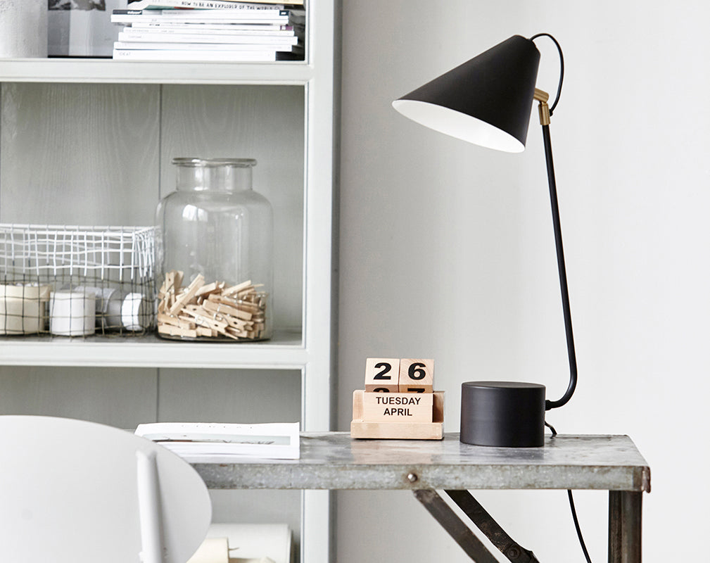 Zinc and steel trestle writing desk with matt black desk lamp.