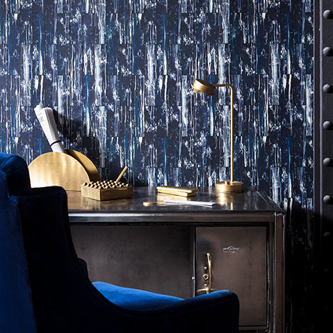 Luxe industrial home office with vintage velvet mixed metals and patinated navy wallpaper