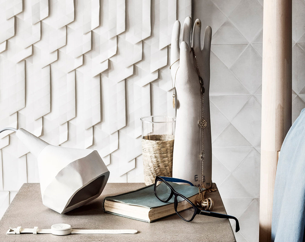 Origami wallpaper with concrete side table and accessories