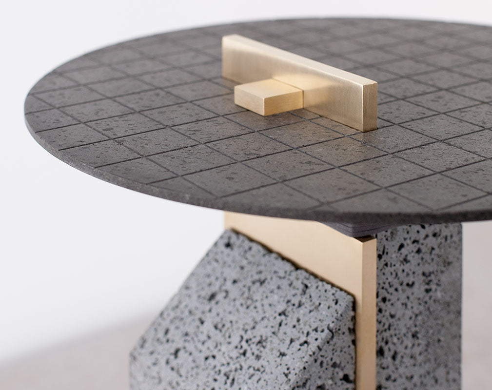 Big Pillar lava stone side table with brass detail from Formafantasma.