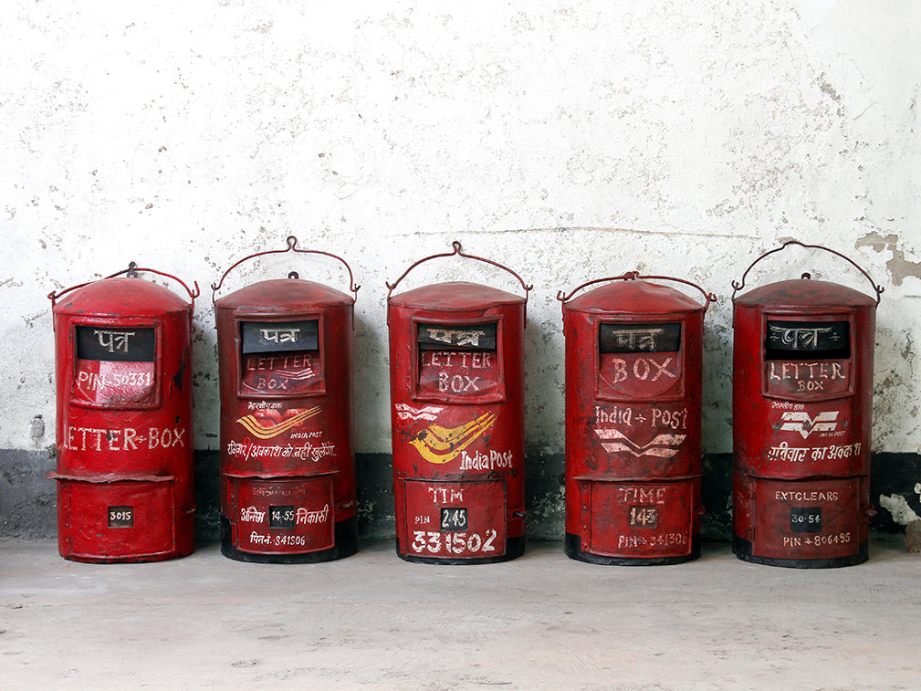 Row of vintage red post boxes sourced from India