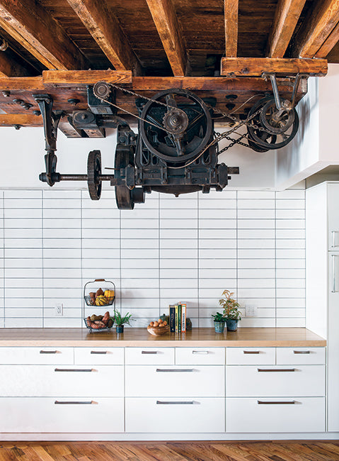 kitchen in a warehouse conversion features large industrial motor as decoration.
