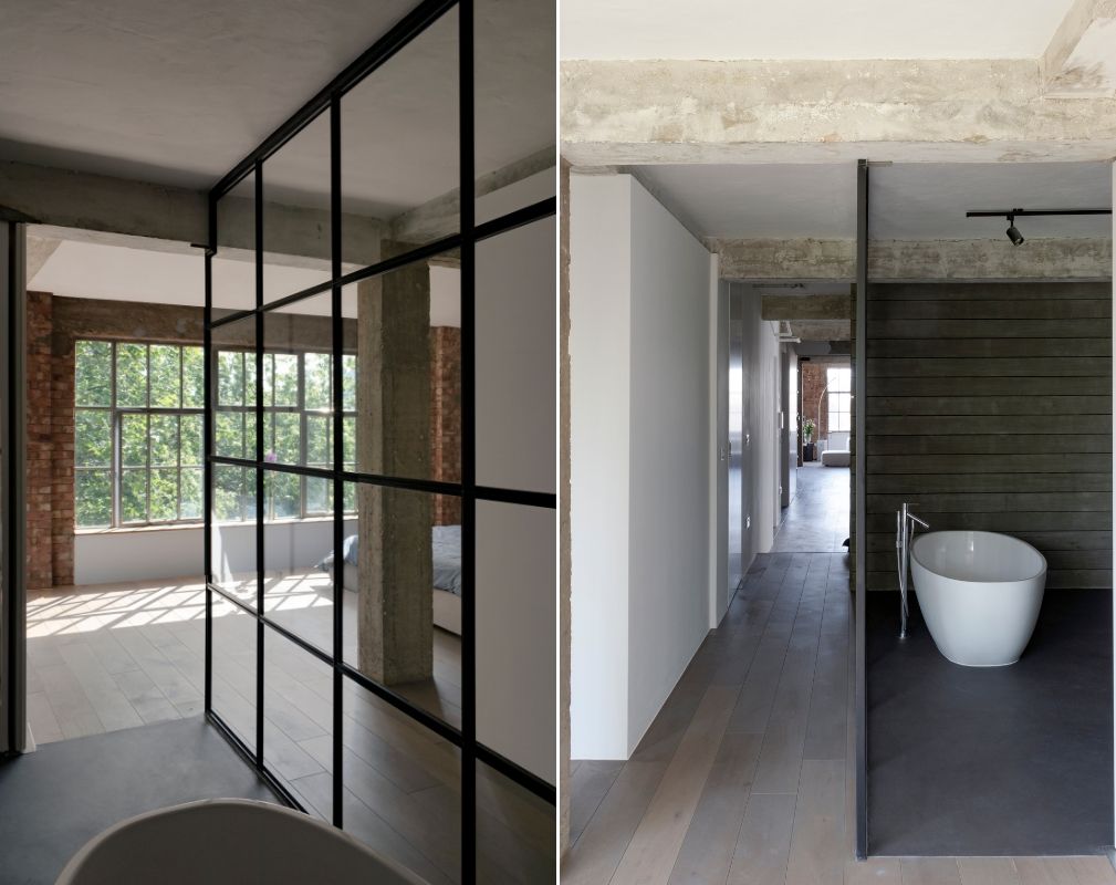The ensuite master bathroom appears open-plan to the bedroom in this converted warehouse home by William Tozer Associates