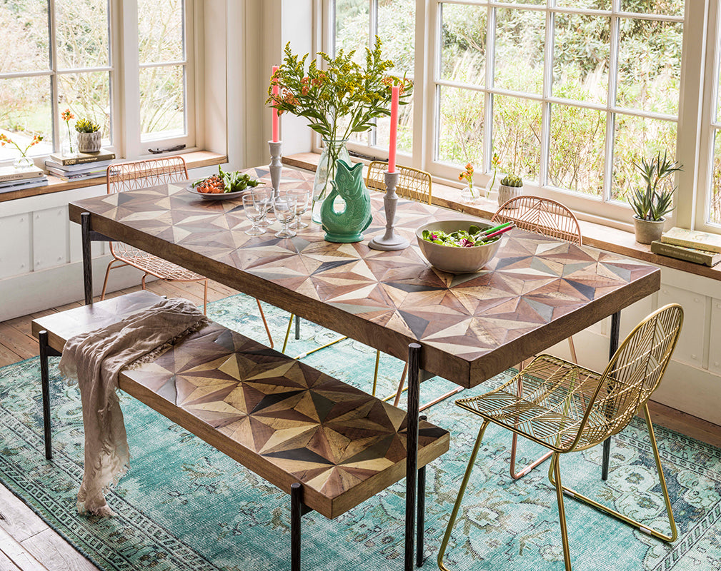the ashton dining table and bench from graham and green features an intricate mango wood top
