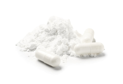 magnesium capsules on white background