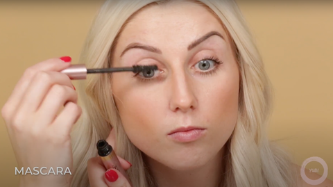 A female beauty vlogger making her eyes pop with mascara