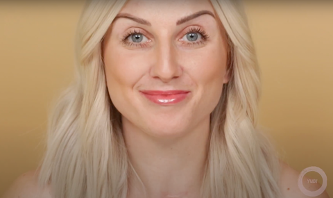 A professional smiling at the camera showing off her easy makeup look