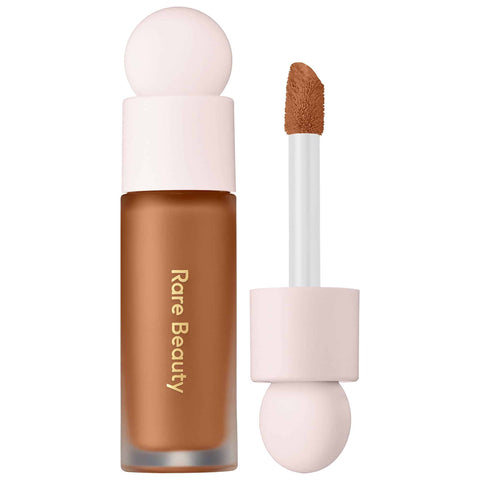 An essential bottle of concealer with the brush applicator