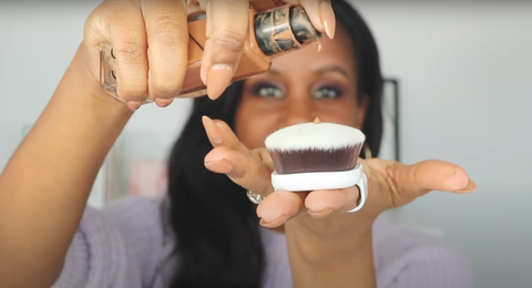 A woman applying flawless foundation using a makeup brush