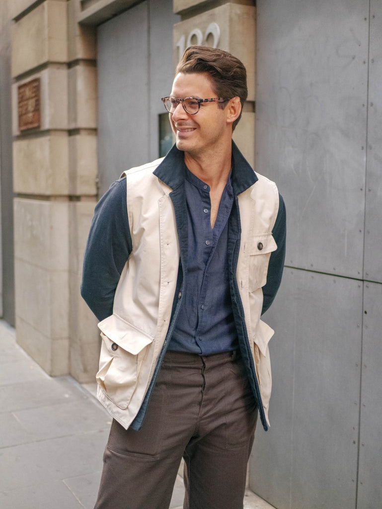 Close_Up_Of_Beige_Utility_Vest_and_Ink_Work_Shirt_Paired_With_Navy_Cotton_Linen_Shirt_and_Chocolate_Fatigue_Pants