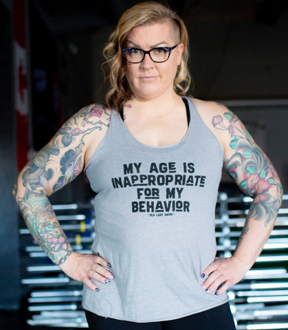 Master female athlete wearing an Old Lady Gains racerback My age is inappropriate for my behavior grey tank top 