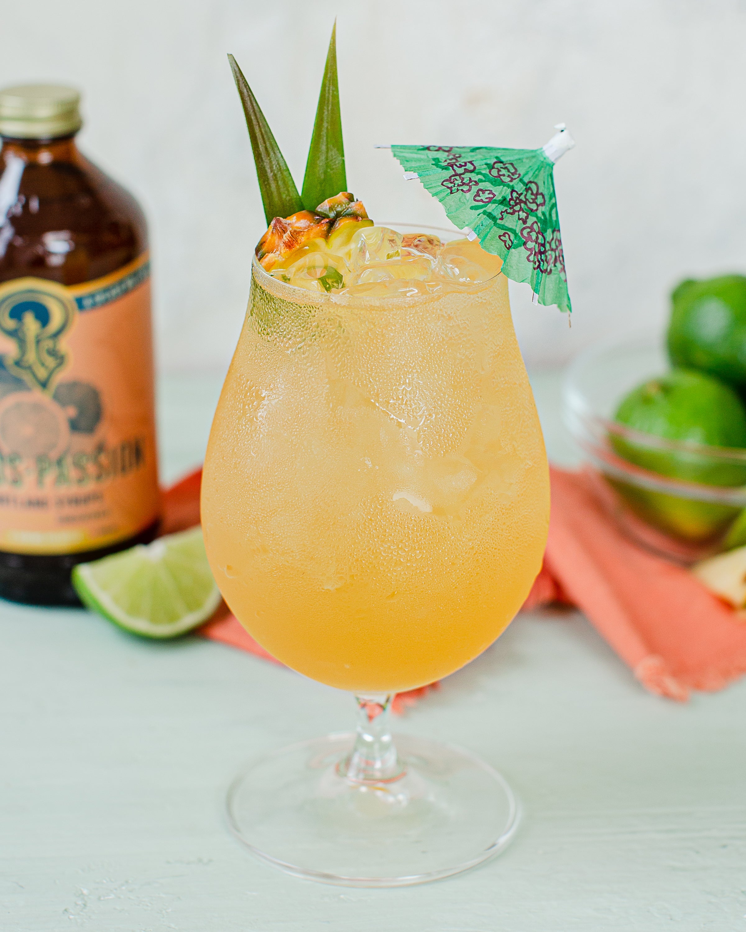 Citrus passionfruit cocktail with umbrella