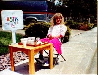 a girl sitting on a table