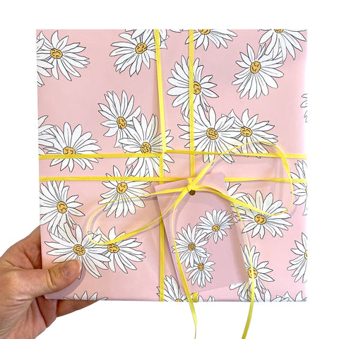 Pink wrapping paper with a white daisy pattern