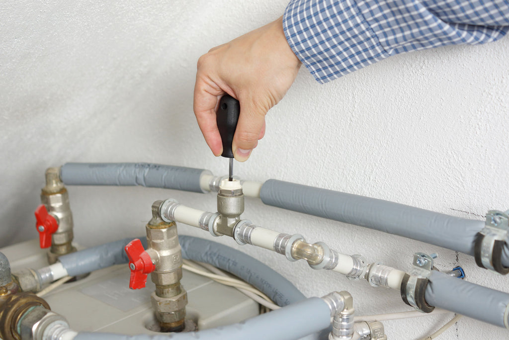 Technician fixing heating system
