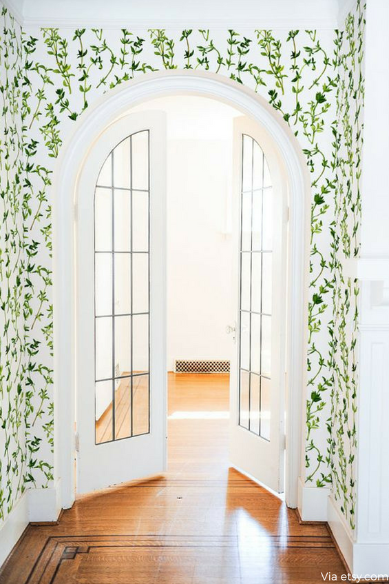 Archway doors with painted vines on the wall 