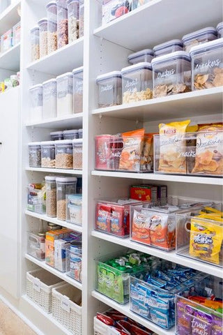 Organized pantry with floor to ceiling shelving 