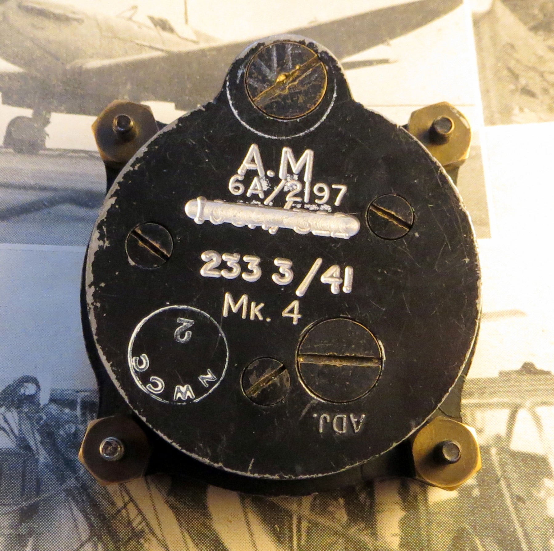 Reverse of 8-day cockpit clock. Note the markings on the back “A.M.” stands for Air Ministry and “41” for 1941, the year of issue. The original serial number has been crossed out and re-engraved, possibly after it was reused in a different aircraft. Incredibly, even though it is nearly 80 years old this particular one is still accurate to within 3 seconds per day, and only needs to be wound once a week.