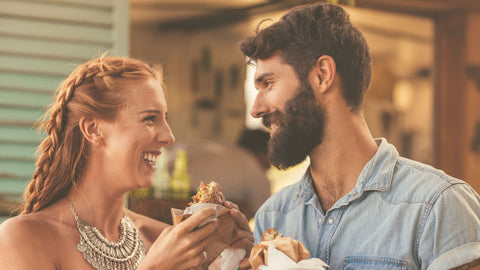 Happy Couple eating burgers together