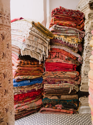 stack of vintage rugs marrakech morocco