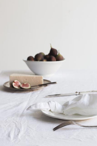 white bowl with figs white plate