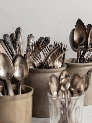 vintage flatware in stoneware pots