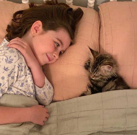 girl and cat in bed