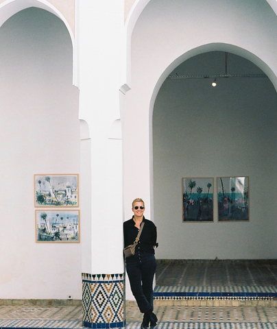 woman in moroccan leaning on column