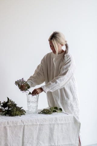 blonde woman arranging flowers